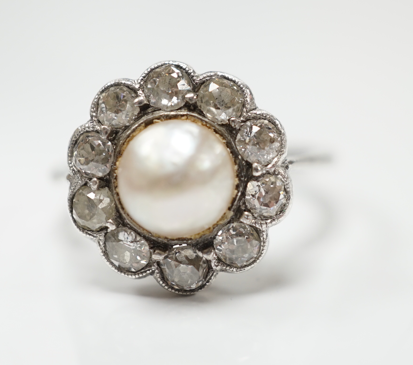 A white metal (stamped Pall) cultured pearl and diamond set circular cluster ring, size L, gross weight 3.3 grams.